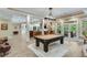 Spacious entertainment room featuring a pool table with access to a bar and the outdoor space at 5623 Brendlynn Dr, Suwanee, GA 30024