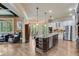 Modern kitchen with stainless steel appliances, granite countertops, and large island at 5623 Brendlynn Dr, Suwanee, GA 30024