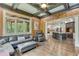 Inviting living room features wood paneling, modern ceiling fan, comfortable seating, and an open view to the kitchen at 5623 Brendlynn Dr, Suwanee, GA 30024