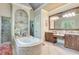 Elegant main bathroom with double vanities, soaking tub, and glass-enclosed shower at 5623 Brendlynn Dr, Suwanee, GA 30024