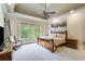 Inviting main bedroom features natural light, tray ceilings, art work, and comfortable seating at 5623 Brendlynn Dr, Suwanee, GA 30024