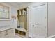 Convenient mudroom featuring built-in storage, bench, and coat hooks for organization at 5623 Brendlynn Dr, Suwanee, GA 30024