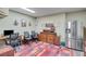 Multi-purpose space with a desk, fridge, and plenty of room for office supplies and working at 5623 Brendlynn Dr, Suwanee, GA 30024