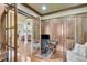 Home office features rich wood paneling, built-in shelves, and a quiet workspace for productivity at 5623 Brendlynn Dr, Suwanee, GA 30024