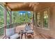 Expansive covered porch featuring a ceiling fan and comfortable seating overlooking the backyard at 5623 Brendlynn Dr, Suwanee, GA 30024