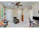 A sitting room boasts a ceiling fan, comfortable seating, and multiple doors that add convenience to the space at 5623 Brendlynn Dr, Suwanee, GA 30024