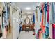 An organized walk-in closet features hanging clothes and a vanity at 5623 Brendlynn Dr, Suwanee, GA 30024