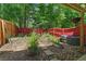 Backyard featuring a garden with a tomato trellis, raised garden beds, and an AC unit at 1689 Camden Forrest Way, Riverdale, GA 30296