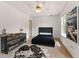 Bedroom featuring a ceiling fan, light colored walls, and a faux cow hide rug for added character at 1689 Camden Forrest Way, Riverdale, GA 30296