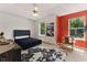 Bright bedroom features a ceiling fan, neutral carpet, and an animal print rug for a trendy vibe at 1689 Camden Forrest Way, Riverdale, GA 30296