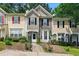Charming townhome with stone accents, manicured landscaping, and inviting walkway to a cozy front porch at 1689 Camden Forrest Way, Riverdale, GA 30296
