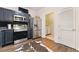 Modern kitchen with stainless steel appliances and adjoining laundry room for convenience at 1689 Camden Forrest Way, Riverdale, GA 30296
