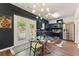 Modern kitchen with stainless steel appliances, dark cabinets, and a cozy dining area with natural light at 1689 Camden Forrest Way, Riverdale, GA 30296