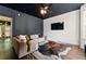 Stylish living room featuring modern wall paneling, hardwood floors, and a sleek, mounted TV at 1689 Camden Forrest Way, Riverdale, GA 30296