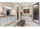 Bathroom featuring double vanity, soaking tub, and walk-in shower at 2220 Peachtree Rd, Cumming, GA 30041