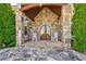 Stone facade entryway featuring a double door and rocking chairs at 2220 Peachtree Rd, Cumming, GA 30041