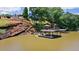 Beautiful lakefront property with private dock, gazebo, and boat slip, surrounded by lush greenery and natural rock formations at 2220 Peachtree Rd, Cumming, GA 30041