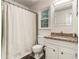 Bright bathroom featuring granite counters, vanity, and shower with patterned curtain at 2982 Huntshire Pl, Atlanta, GA 30340