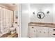 Bathroom featuring granite counters, updated lighting, and shower with patterned curtain at 2982 Huntshire Pl, Atlanta, GA 30340