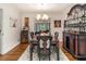 Elegant dining room with hardwood floors, a vintage table, and a decorative cabinet at 2982 Huntshire Pl, Atlanta, GA 30340