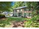 Beautiful brick home with green shutters surrounded by lush greenery at 2982 Huntshire Pl, Atlanta, GA 30340