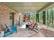 Inviting covered patio with stylish Adirondack chairs and a cozy fire pit, perfect for outdoor relaxation and entertaining at 2982 Huntshire Pl, Atlanta, GA 30340