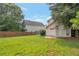 Wide-open backyard with a well-maintained lawn, wooden fence, and mature trees for privacy at 3984 Oak Glenn Dr, Duluth, GA 30096