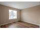 Spacious bedroom featuring wood-look flooring, neutral walls, and a bright window at 3984 Oak Glenn Dr, Duluth, GA 30096