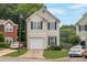 Charming two-story home with a light exterior, attached garage, and a well-manicured lawn at 3984 Oak Glenn Dr, Duluth, GA 30096