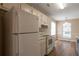 Cozy kitchen with white appliances, ample cabinet space, and a view of the backyard at 3984 Oak Glenn Dr, Duluth, GA 30096