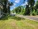 View of the side yard and street in front of the house, with a car parked along the road at 53 Elm St, Hampton, GA 30228