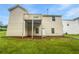 Exterior of home featuring a wooden deck and spacious backyard at 6560 Alford Way, Lithonia, GA 30058