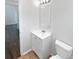 Bathroom features a vanity with a sink and mirror, complemented by tile flooring at 6560 Alford Way, Lithonia, GA 30058