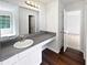 Bathroom features a vanity with a sink and mirror, complemented by wood-look flooring at 6560 Alford Way, Lithonia, GA 30058