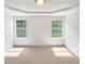Bright bedroom with large windows overlooking a well-manicured yard at 6560 Alford Way, Lithonia, GA 30058