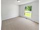Bright bedroom with neutral carpet, white walls and large window providing ample natural light at 6560 Alford Way, Lithonia, GA 30058