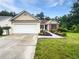 Charming single-story home with a two-car garage, manicured lawn, and inviting curb appeal at 6560 Alford Way, Lithonia, GA 30058