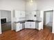 Kitchen features wood floors, granite counters, stainless steel appliances and bright white cabinets at 6560 Alford Way, Lithonia, GA 30058