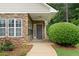 Inviting entryway showcasing a brick facade, covered porch with ceiling fan, and manicured garden beds at 3734 Villa Springs Cir, Powder Springs, GA 30127
