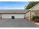 Attached two-car garage for convenient parking and storage, with a long driveway at 3734 Villa Springs Cir, Powder Springs, GA 30127