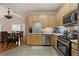Bright kitchen features wood cabinets, stainless appliances, and adjacent dining area at 3734 Villa Springs Cir, Powder Springs, GA 30127