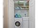 Convenient laundry closet features a washer, dryer, and shelving for storage at 3734 Villa Springs Cir, Powder Springs, GA 30127