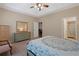 Comfortable bedroom with tray ceiling, a dresser and chair, plus an ensuite bathroom and closet at 3734 Villa Springs Cir, Powder Springs, GA 30127
