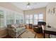 Cozy sunroom features many windows, letting in plenty of natural light, and comfortable seating at 3734 Villa Springs Cir, Powder Springs, GA 30127