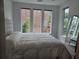 The main bedroom boasts multiple large windows providing ample natural light and neighborhood views at 401 Burton Dr, Alpharetta, GA 30009