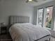 This main bedroom has a large window for natural light and a neutral color palette at 401 Burton Dr, Alpharetta, GA 30009