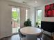 Dining room features a round table, patio access, modern art, and natural light at 401 Burton Dr, Alpharetta, GA 30009