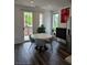 Dining room features a round table, patio access, modern art, and natural light at 401 Burton Dr, Alpharetta, GA 30009