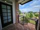 Brick townhouse entryway, featuring a black railing and a view of a park at 401 Burton Dr, Alpharetta, GA 30009