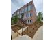 Brick townhouse with a private entrance, black railings, and manicured landscaping at 401 Burton Dr, Alpharetta, GA 30009
